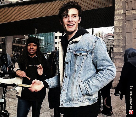 Shawn Mendes in a black hoodie and a sherpa lined denim jacket