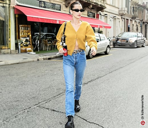 Bella Hadid wearing mom jeans and a mustard yellow knit sweater