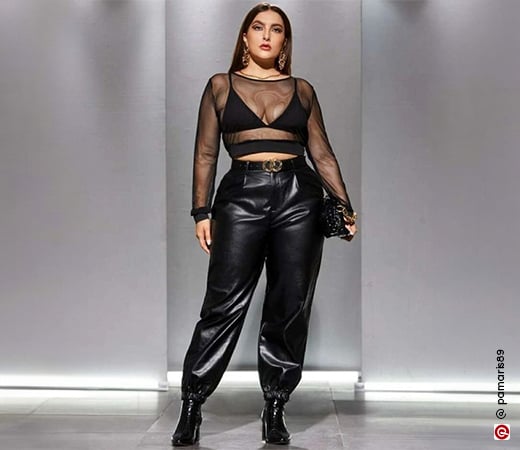 Woman wearing black sheer top and leather pants 