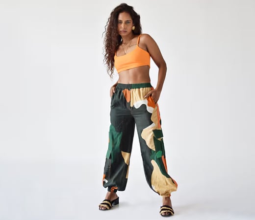 The Missy Co. Green pants with yellow, abstract white and orange shapes