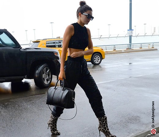 Kendall Jenner wearing black joggers and cheetah print boots