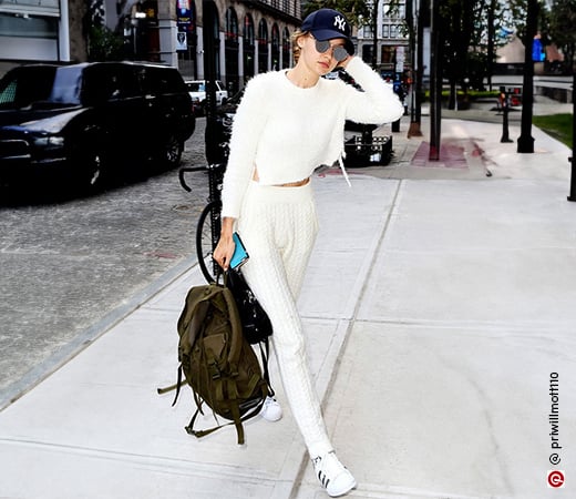 Gigi Hadid wearing a white sweater and knitted joggers