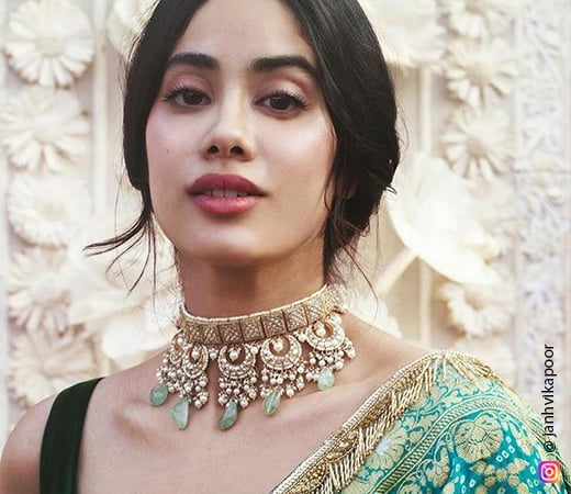 Jahnvi Kapoor wearing a gold and green necklace
