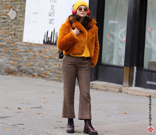 Selena Gomez in an orange fur coat