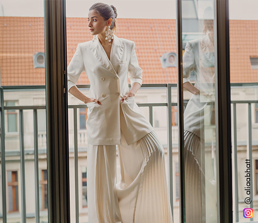 Alia Bhatt wearing white pleated flared pants and jacket