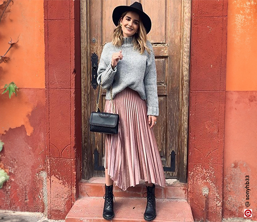  Woman in a grey sweater and pink skirt