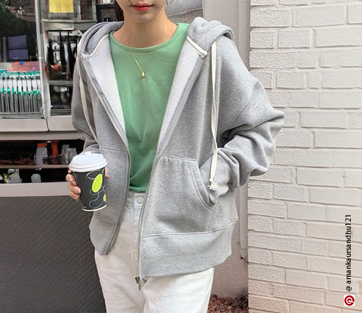 Woman wearing grey zip-up hoodie