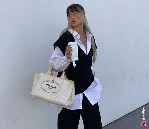 Woman wearing a white shirt with a black vest sweater