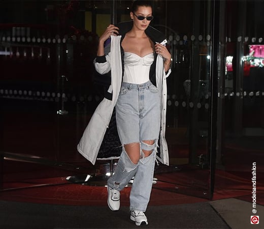 Bella Hadid wearing baggy jeans and a fitted white top