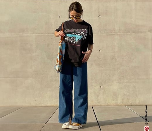 Woman wearing an oversized t-shirt with baggy jeans