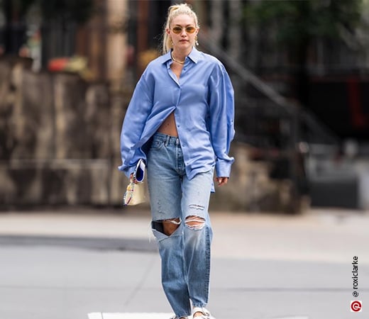 Gigi Hadid wearing baggy jeans and an oversized shirt