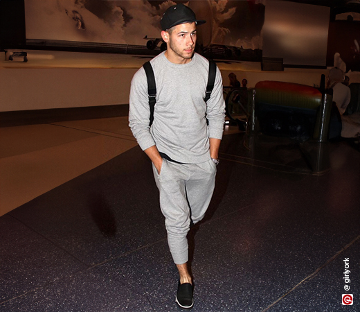 Nick Jonas wearing grey sweatpants 