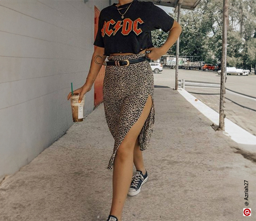 Woman in graphic tee and leopard print skirt
            