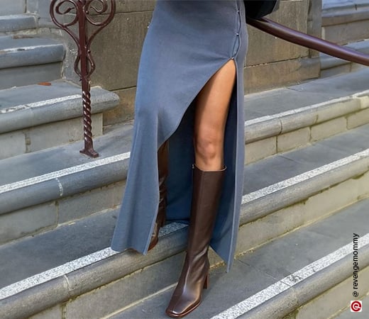 Woman wearing grey thigh-high split skirt and brown leather boots
