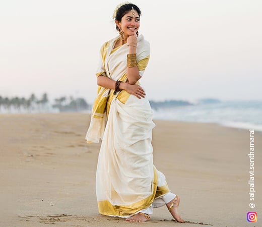 Sai Pallavi wearing a traditional white and gold saree