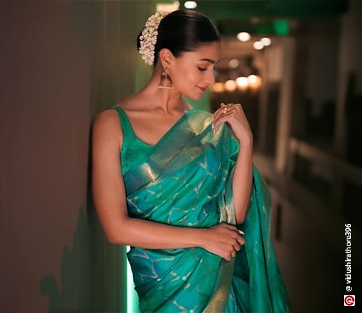 Alia Bhatt wearing a green saree and floral hairstyle