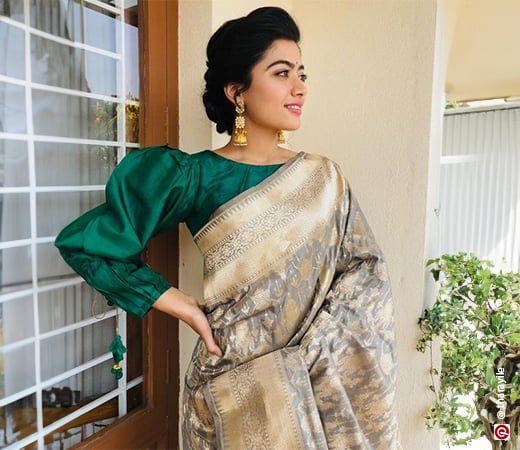 Rashmika Mandana wearing a Kanjivaram saree with a contrast blouse