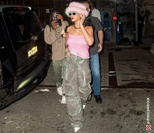 Rihanna wearing a pink spaghetti strap top with oversized grey cargo pants