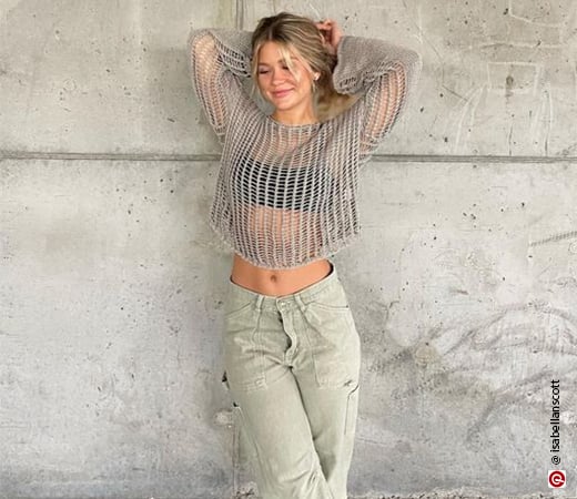 Woman wearing grey crochet top with a bralette and cargo pants.