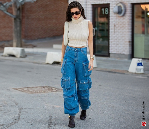 Model wearing denim cargo pants with black strappy heels.