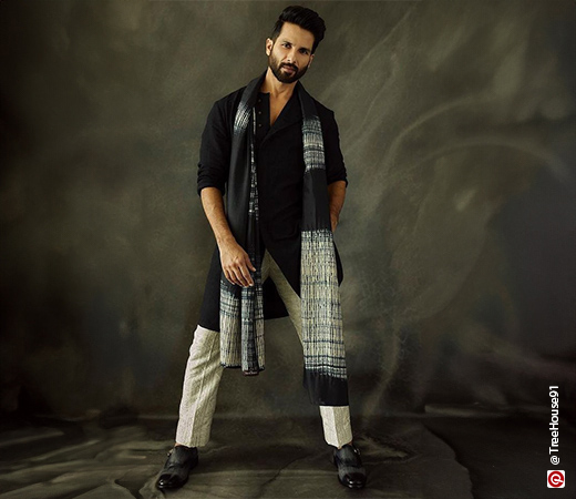 Shahid Kapoor wearing a black kurta with a black and white stole