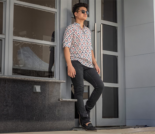 Model wearing a printed short kurta with grey jeans