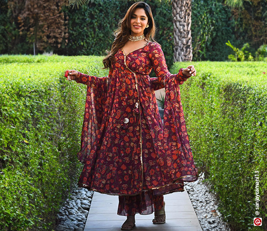 Woman wearing a purple floral Angarkha suit