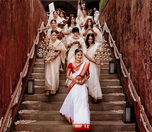 Mouni Roy’s bridesmaids wearing white Kasavu sarees
