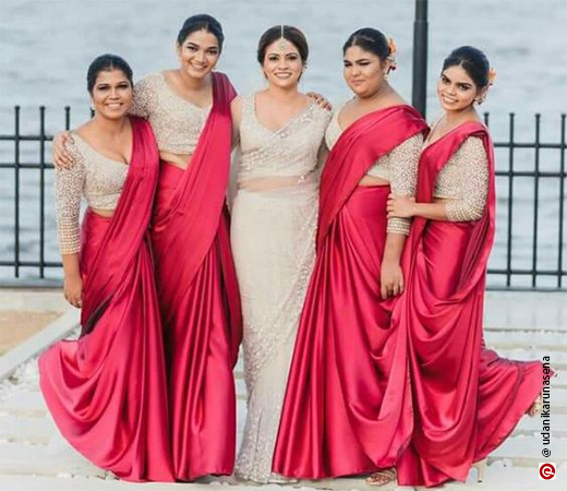  Women wearing a red satin saree