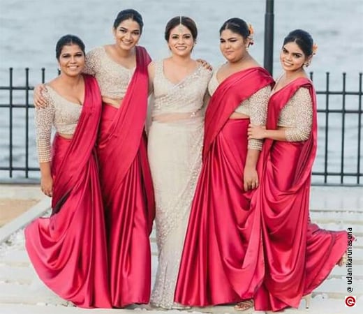  Women wearing a red satin saree