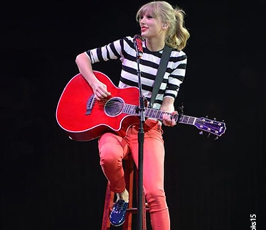Taylor Swift wearing a striped t-shirt and red pants