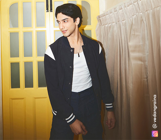 Vedang Raina in a black jacket and navy blue trousers