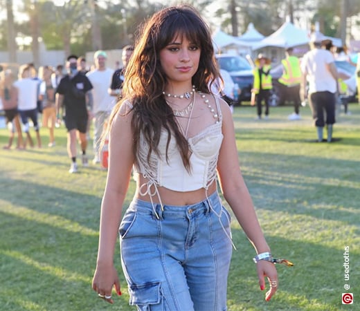 Camila Cabello wearing a crop top and jeans