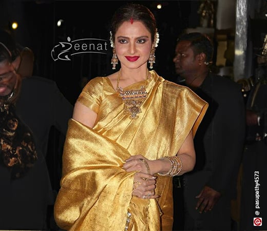 Rekha wearing a gold silk saree