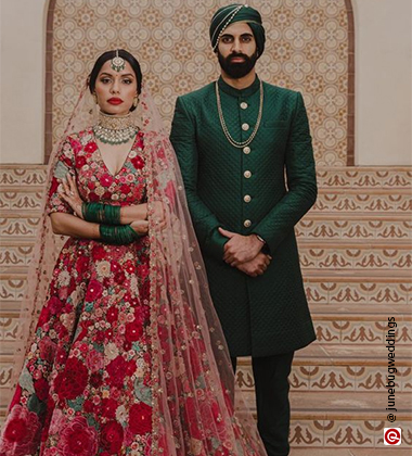 groom wearing green and bried wearing red
